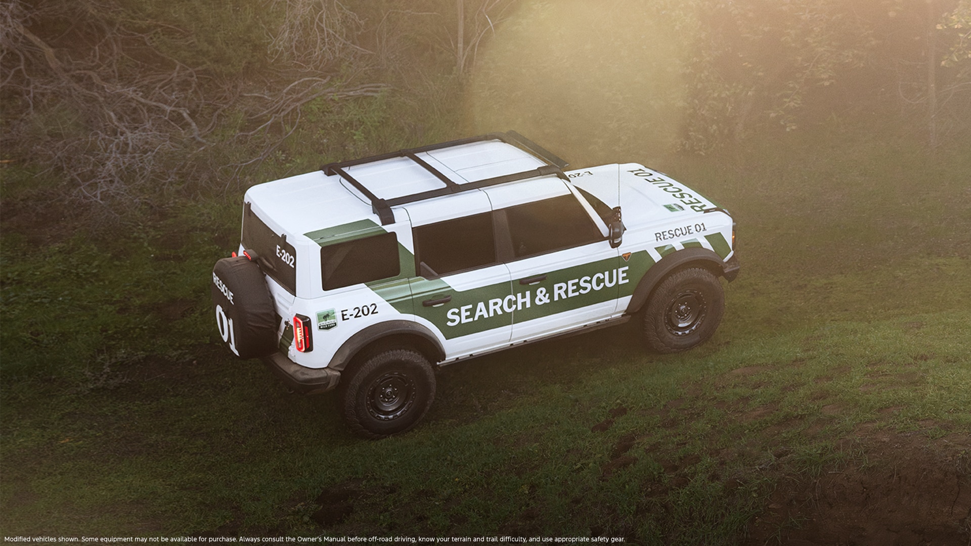 A white Ford Bronco with a dark green stripe around the outside and the words "Search and Rescue" on it.